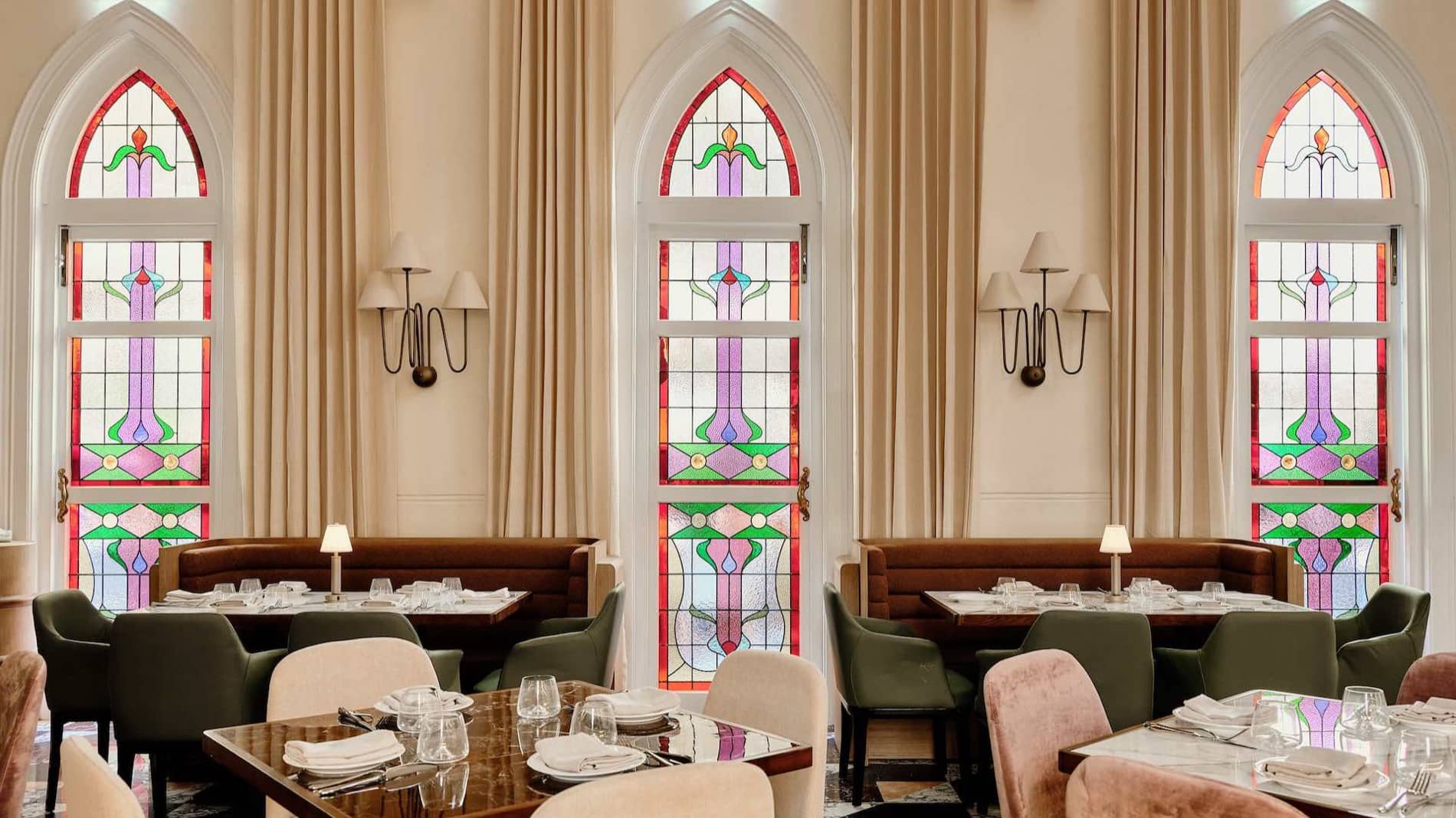 Aambra dining room beneath the church's original stained-glass windows